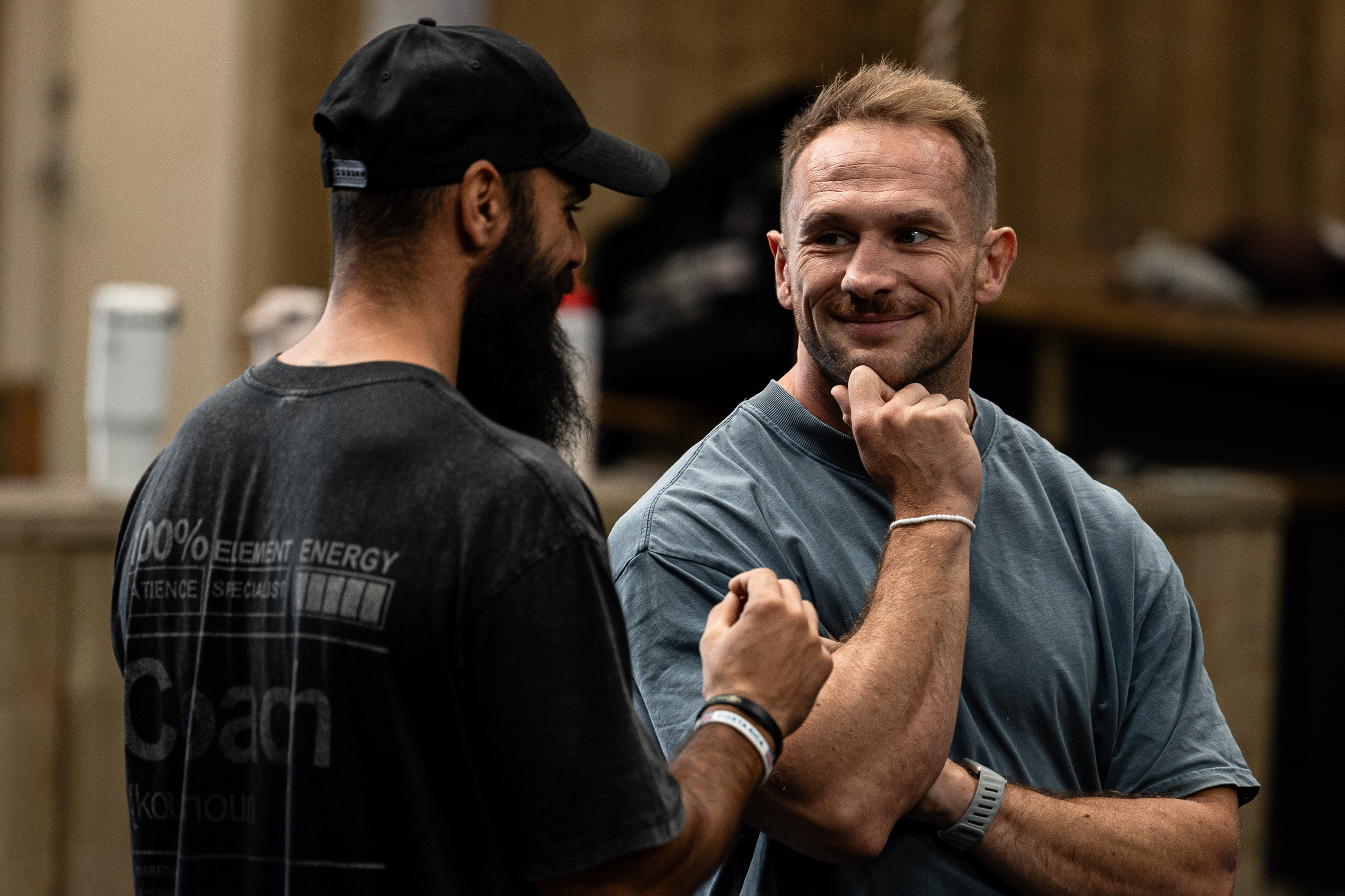 A WSX coach and member talking through a session on the training floor