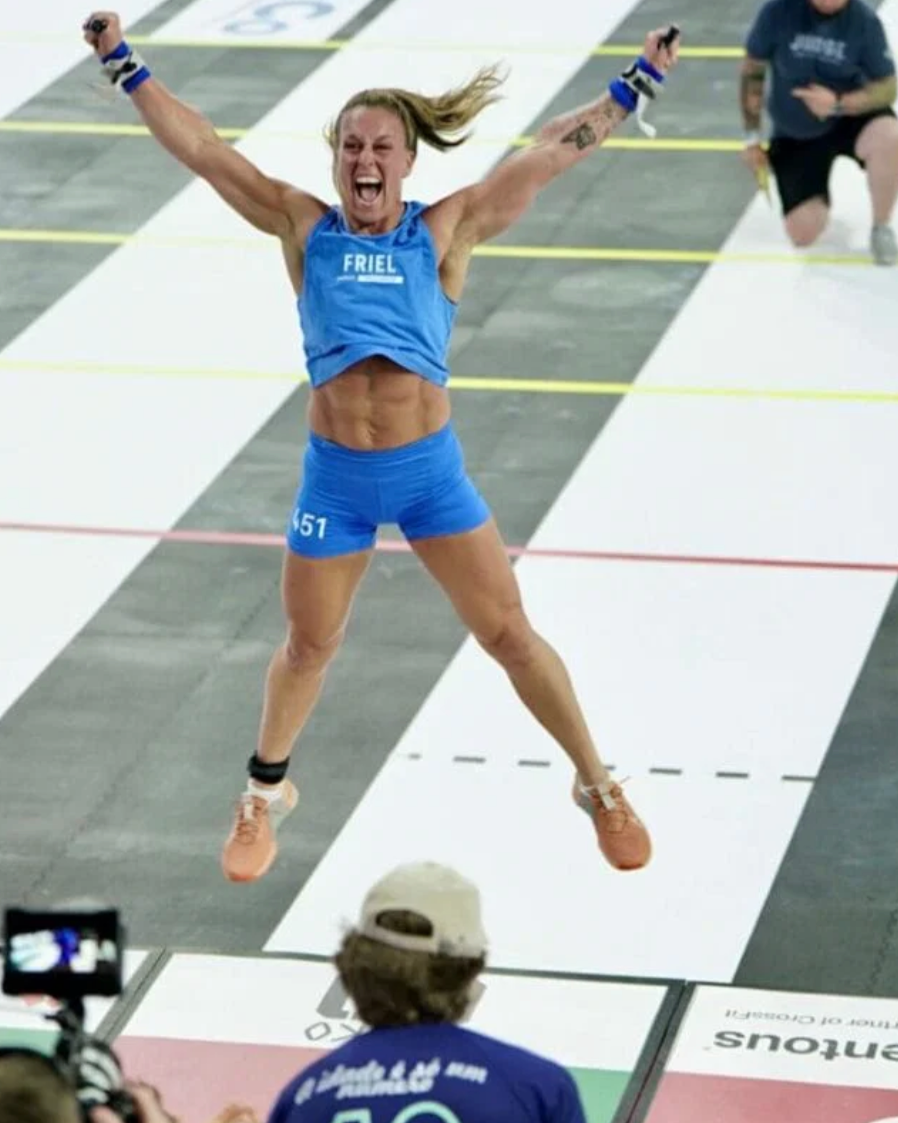 Kelly Friel, WSX coach, mid-air on the CrossFit Games competition floor
