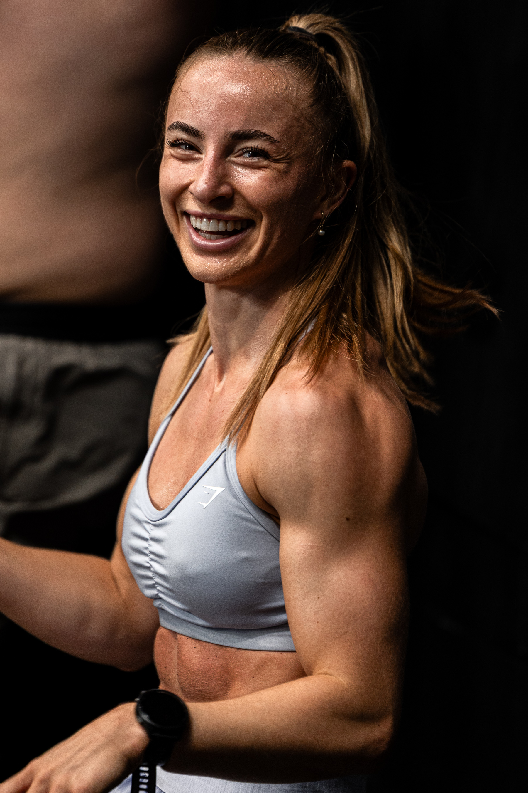 A WSX member smiling mid-session on the training floor