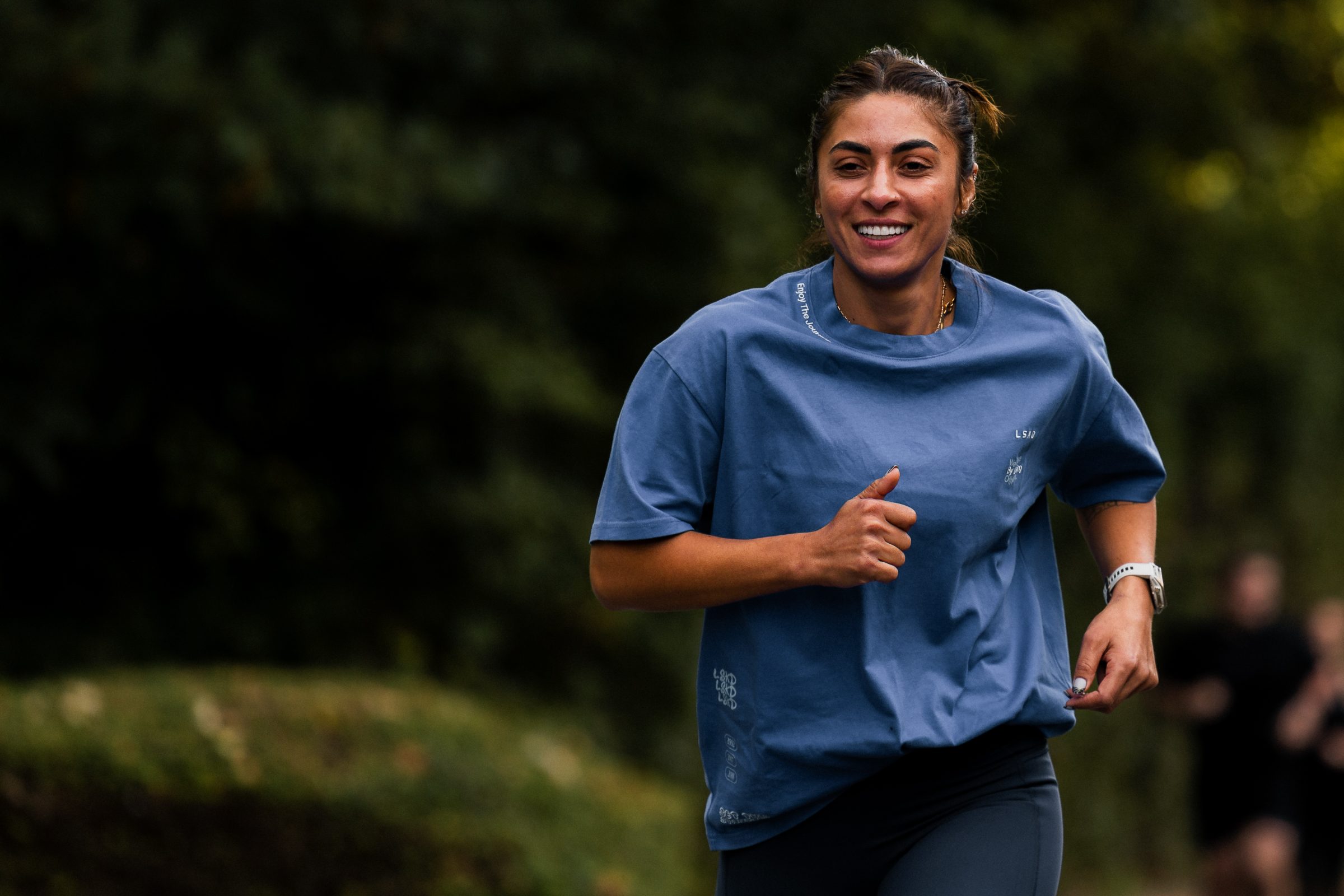 A WSX Run Club member mid-run, smiling